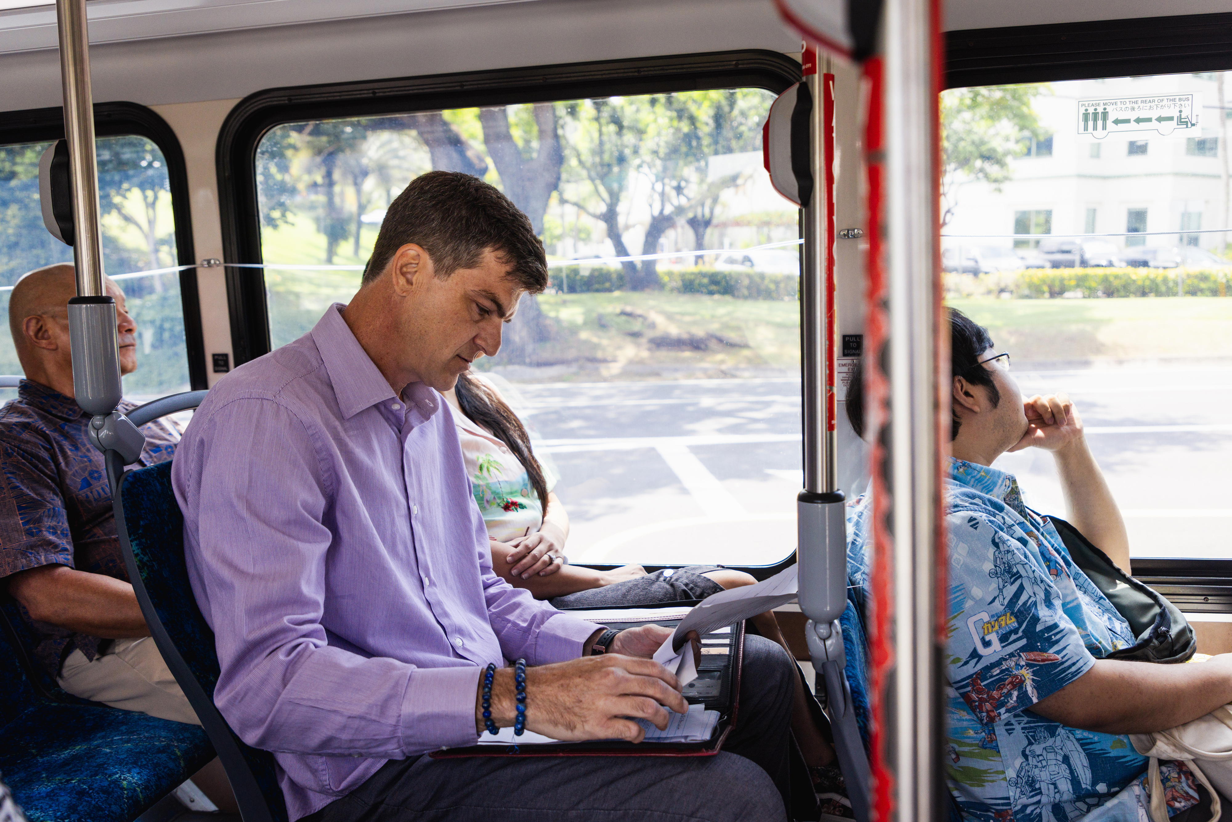 Image of working professionals on the bus 2